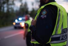 Officer standing near police vehicle